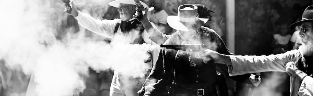 Image of cowboys shooting pistols in USA