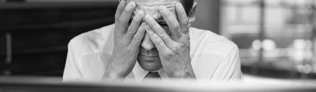 Frustrated man in front of a computer